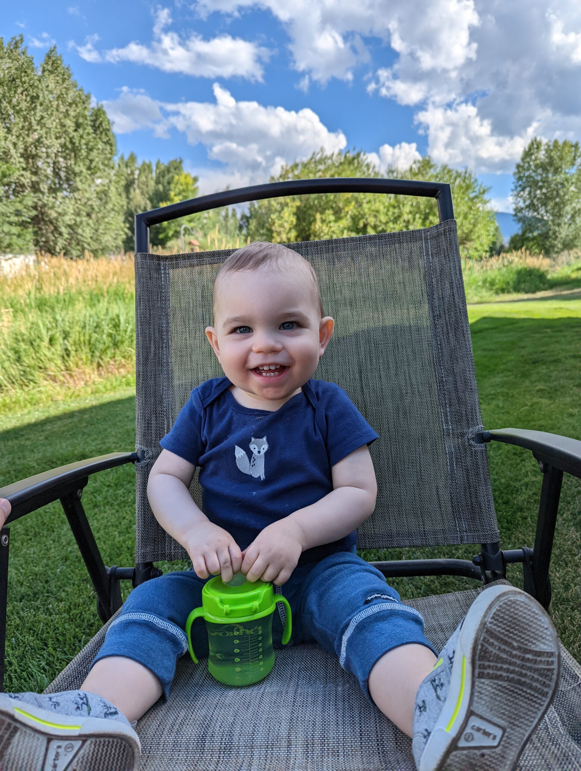 Small child sitting in chair smiling